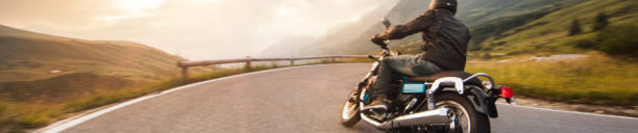 Motorcycle driver riding in Dolomite pass, Italy, south Europe.